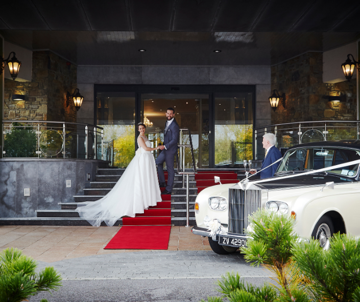 Wedding couple at front of hotel