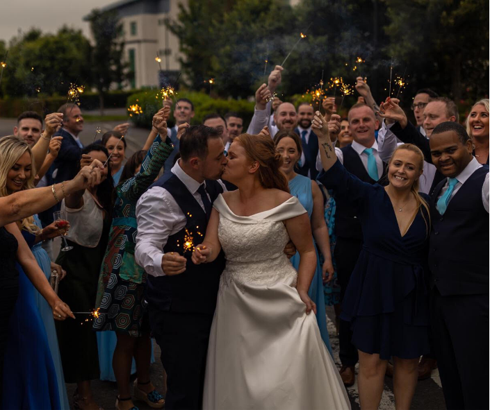 Wedding couple with guests outside The Rose Hotel